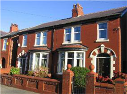 Fig. 22 Intact decorative brick boundary walls and gatepiers with terracotta details, Longton Road