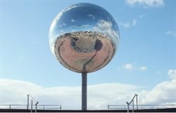 Giant mirror ball on seafront.