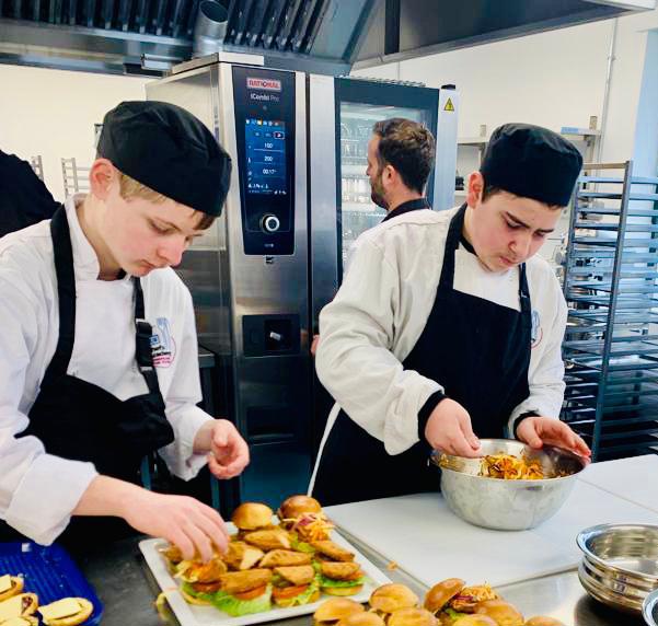 Chef Academy students prepping food in kitchen