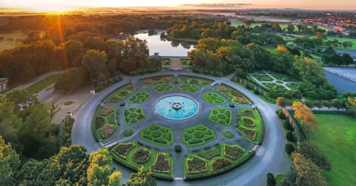 Aerial view of park with fountain and lake