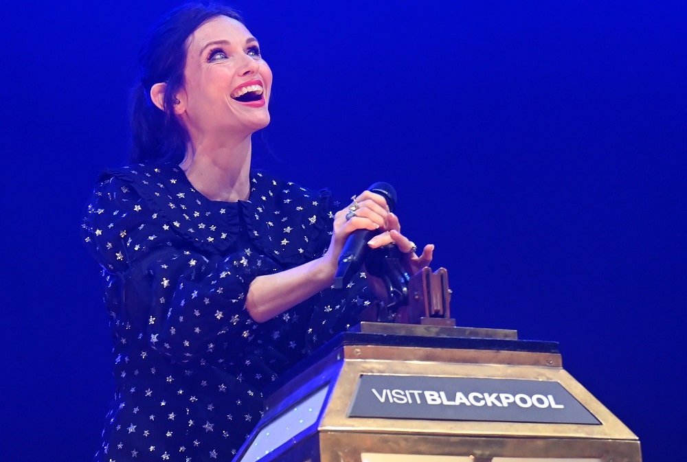 Woman with spotty dress pulls a large antique switch