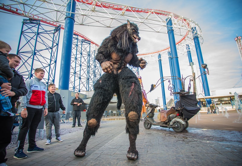Werewolf stood under large roller coaster