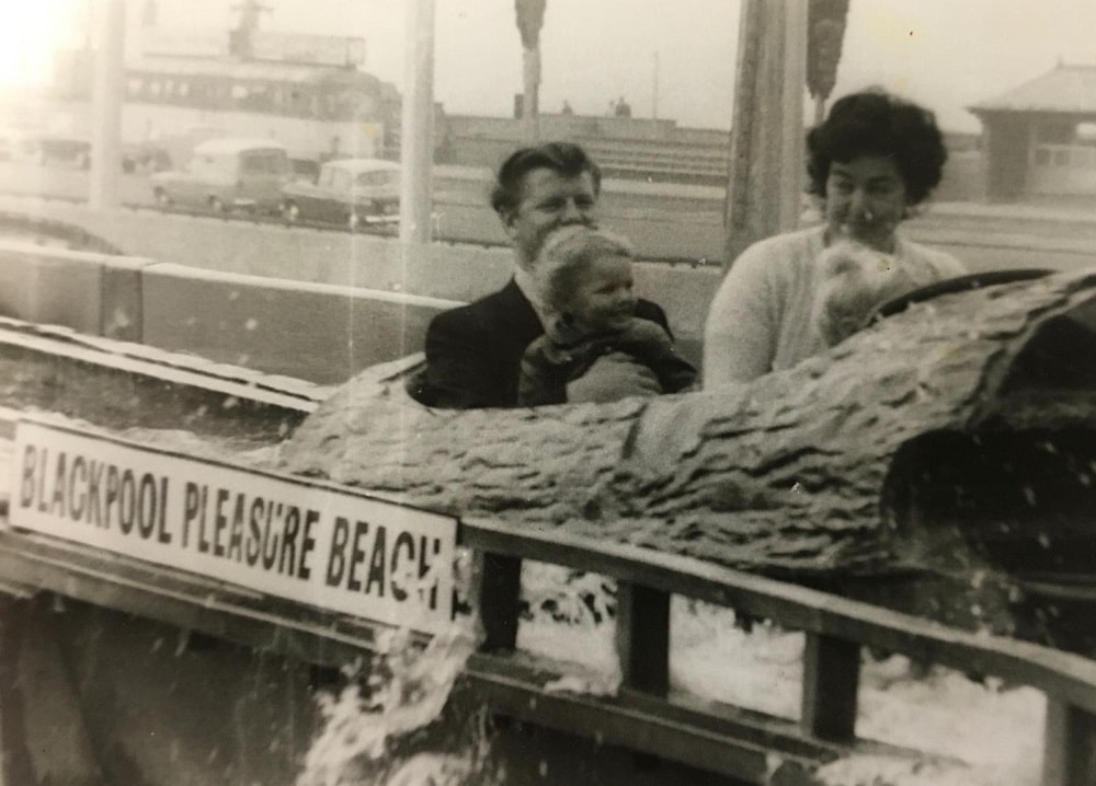 Family group sat in log flume ride.