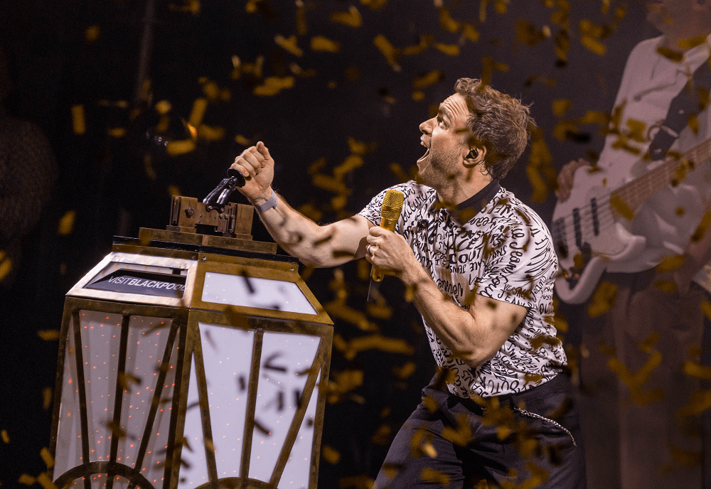 Man pull large switch surrounded by confetti.