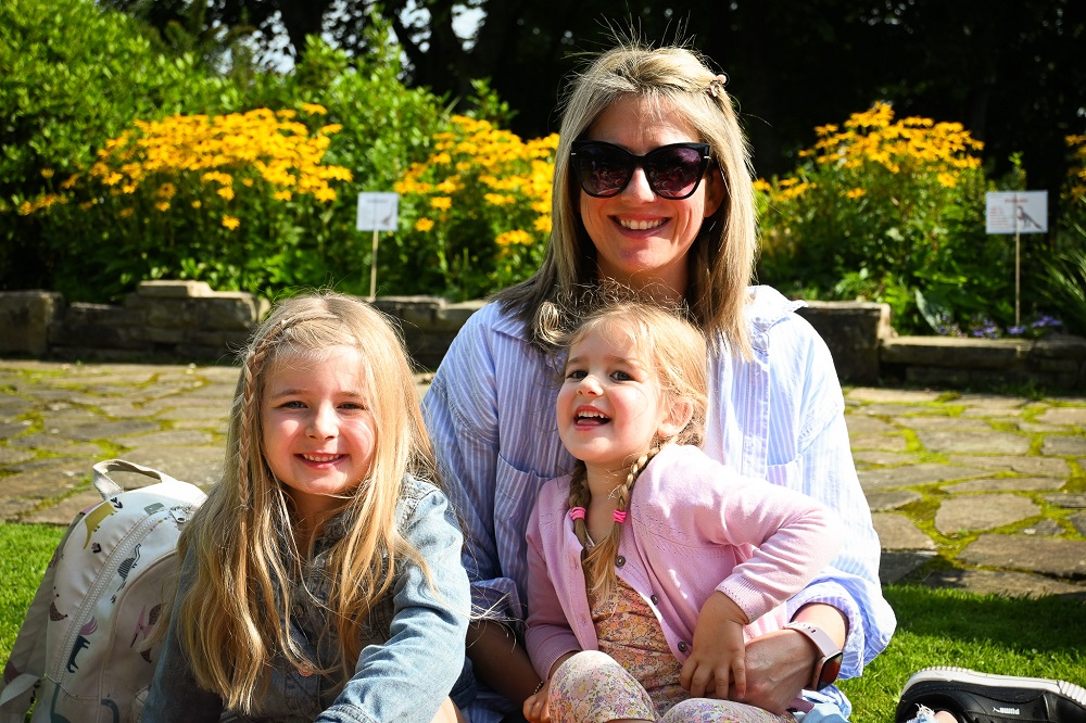 A mum and two children outside enjoying a Blackpool park.