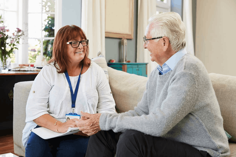 Two people chatting on a sofa 