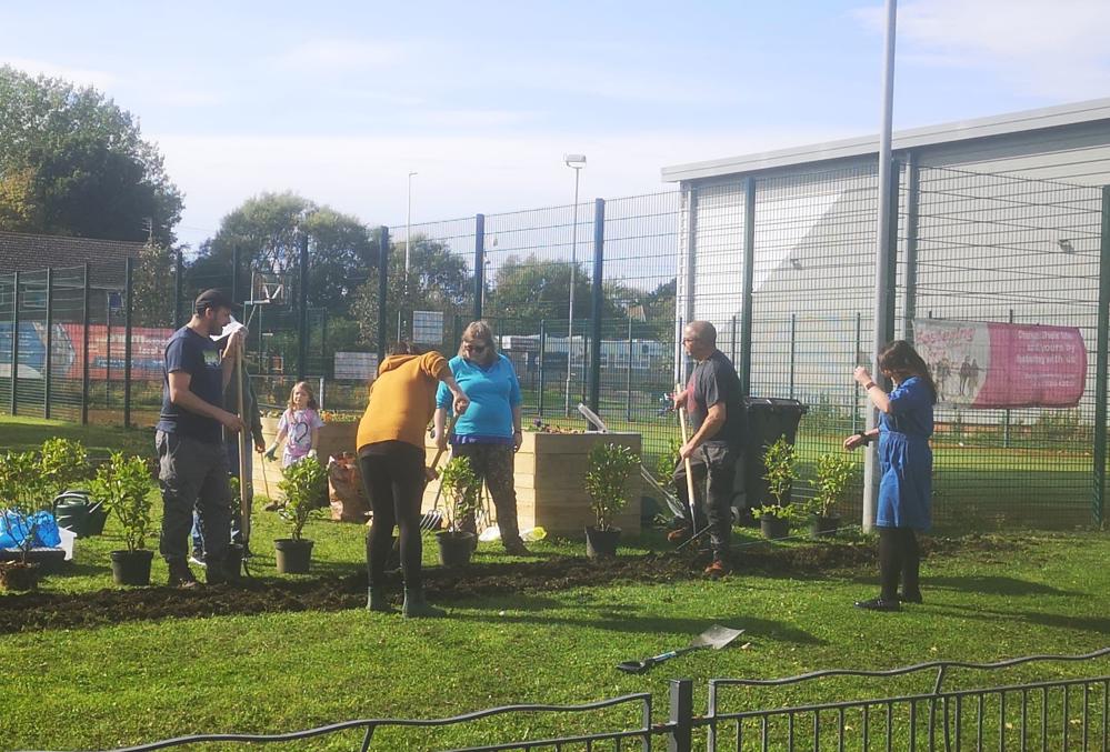 Group of people gardening in a community garden