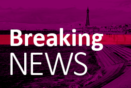 Breaking news with promenade and tower in background