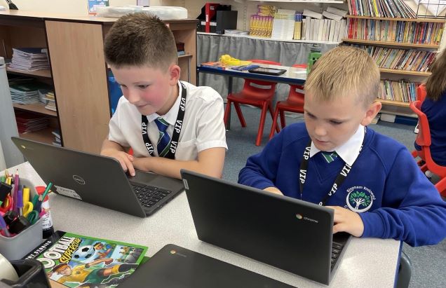 Alfie Jack Turner and Isaac Smith from Bispham Endowed Primary on laptops
