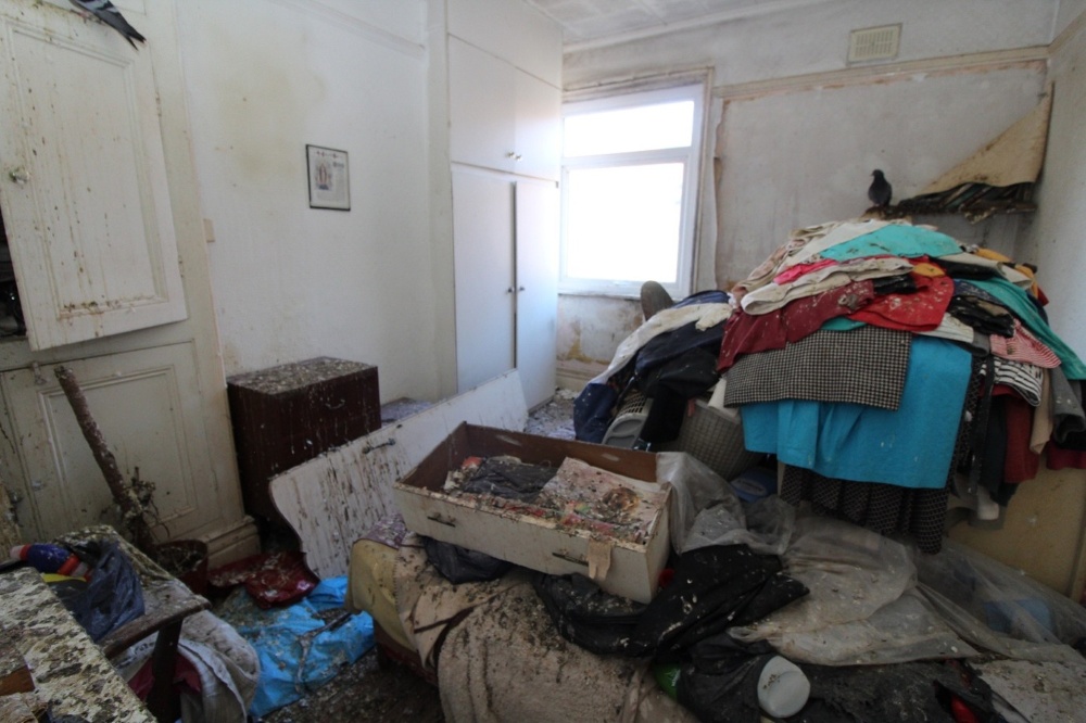 Image shows a bedroom in a poor state of repair, with pigeon droppings across the surfaces