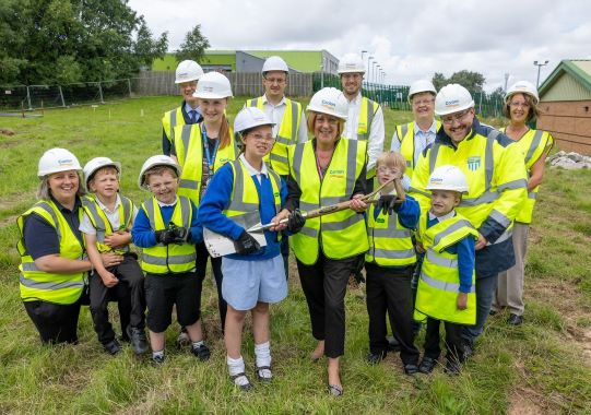 Councillor Kath Benson with school kids from Highfurlong School wearing high visibility vests and and hard hats