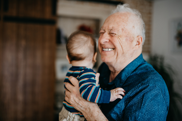 An older person holding a baby 