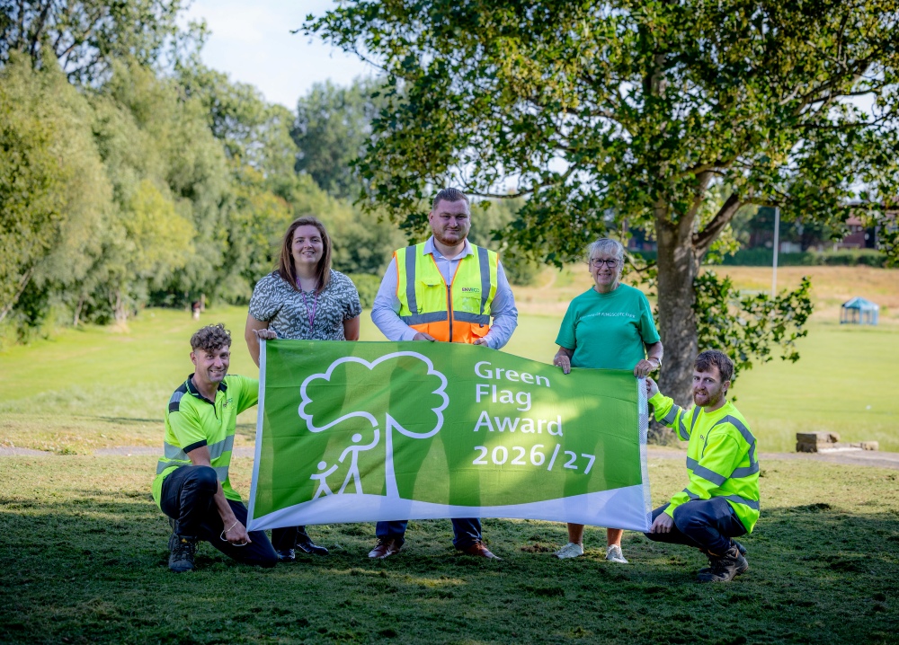 Five people holding the green flag award 