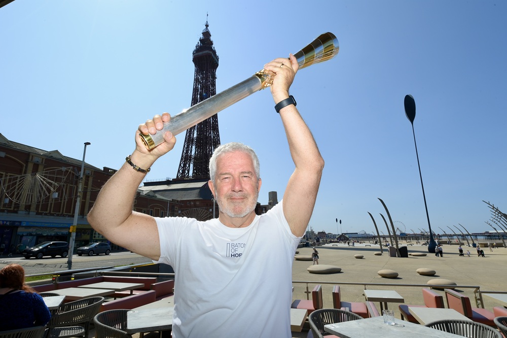 Mike McCarthy with the Baton of Hope in front of The Blackpool Tower