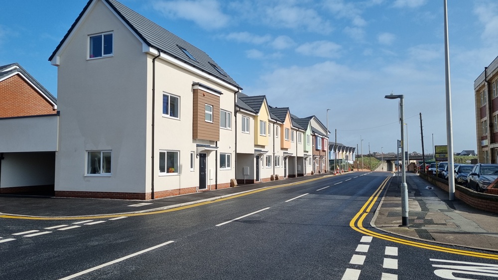 Newly resurfaced road with housing