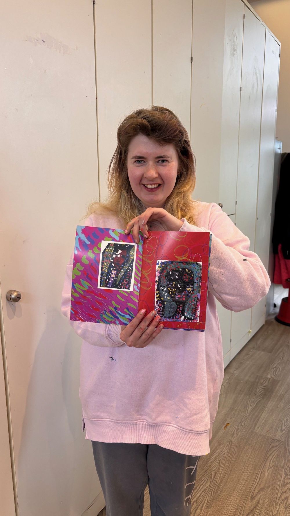 Artist Chloe showing off her collection of works
