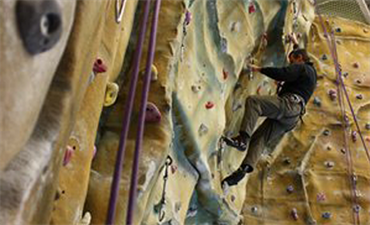Man climbing the climbing wall at Blackpool Sports Centre