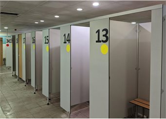 Changing rooms with yellow stickers and numbers on at Blackpool Sports Centre