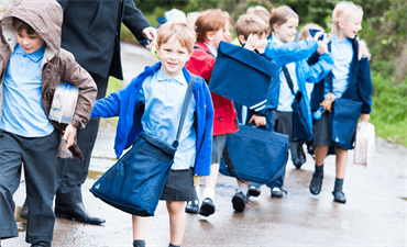 Group of school children walking in double file