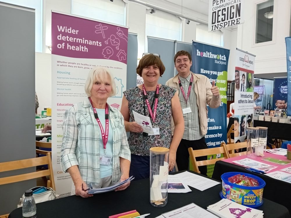 Group of co-researchers at a stall at the Blackpool and Fylde College Freshers Fair