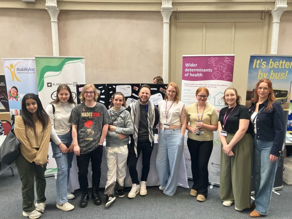 Group image in front of the stand at the Spring into Spring event