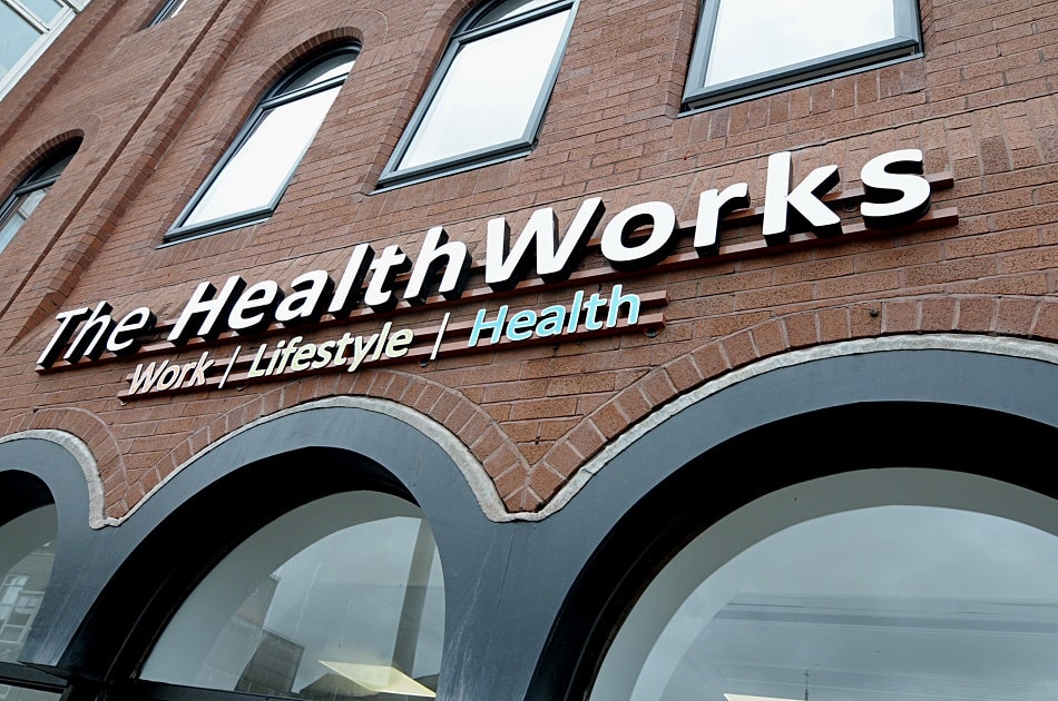 Sign over three curved windows The Health Works.