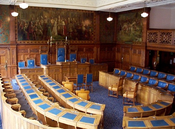 Oak paneled curved seating and desks.