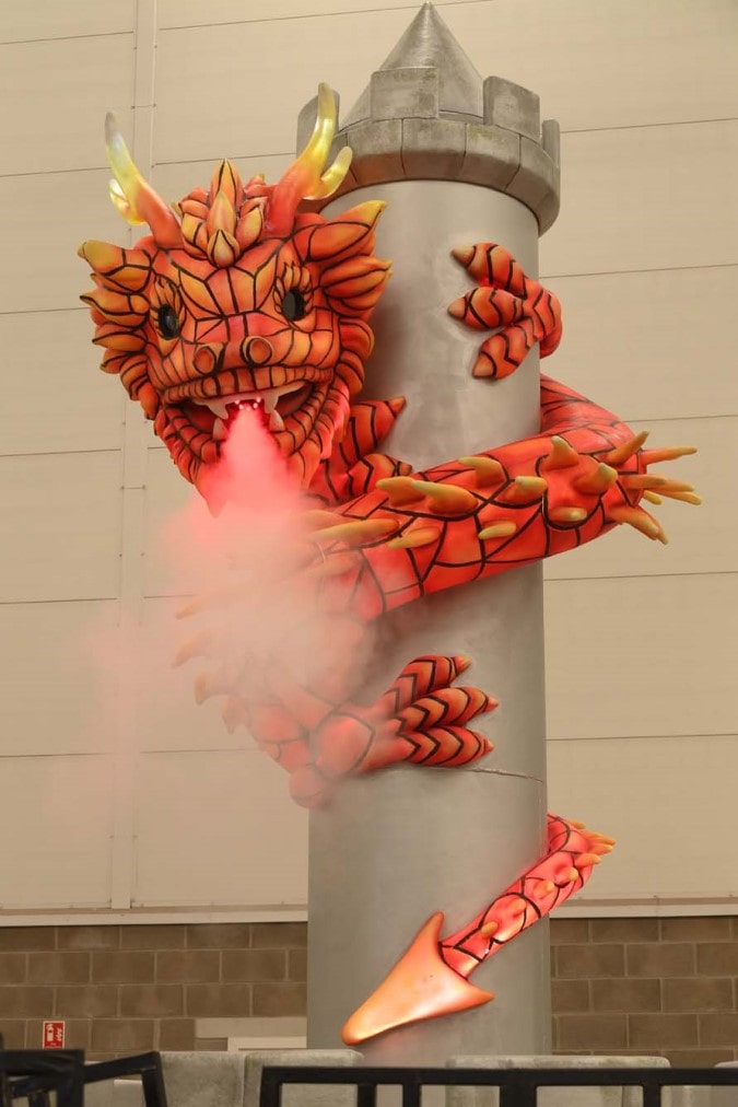 Illuminated draggon around tower.