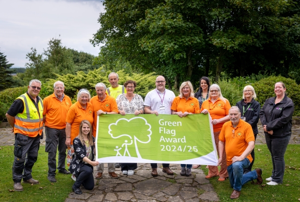 People holding a Green Flag award flag