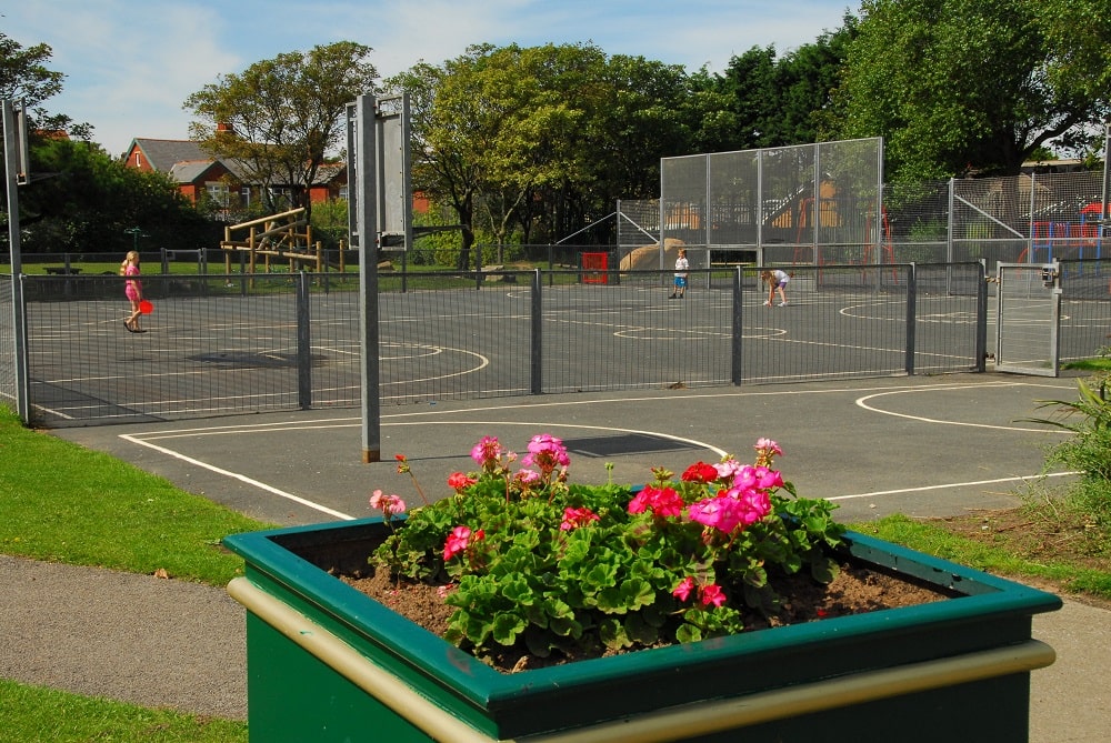 Flower planter  and tennis court.