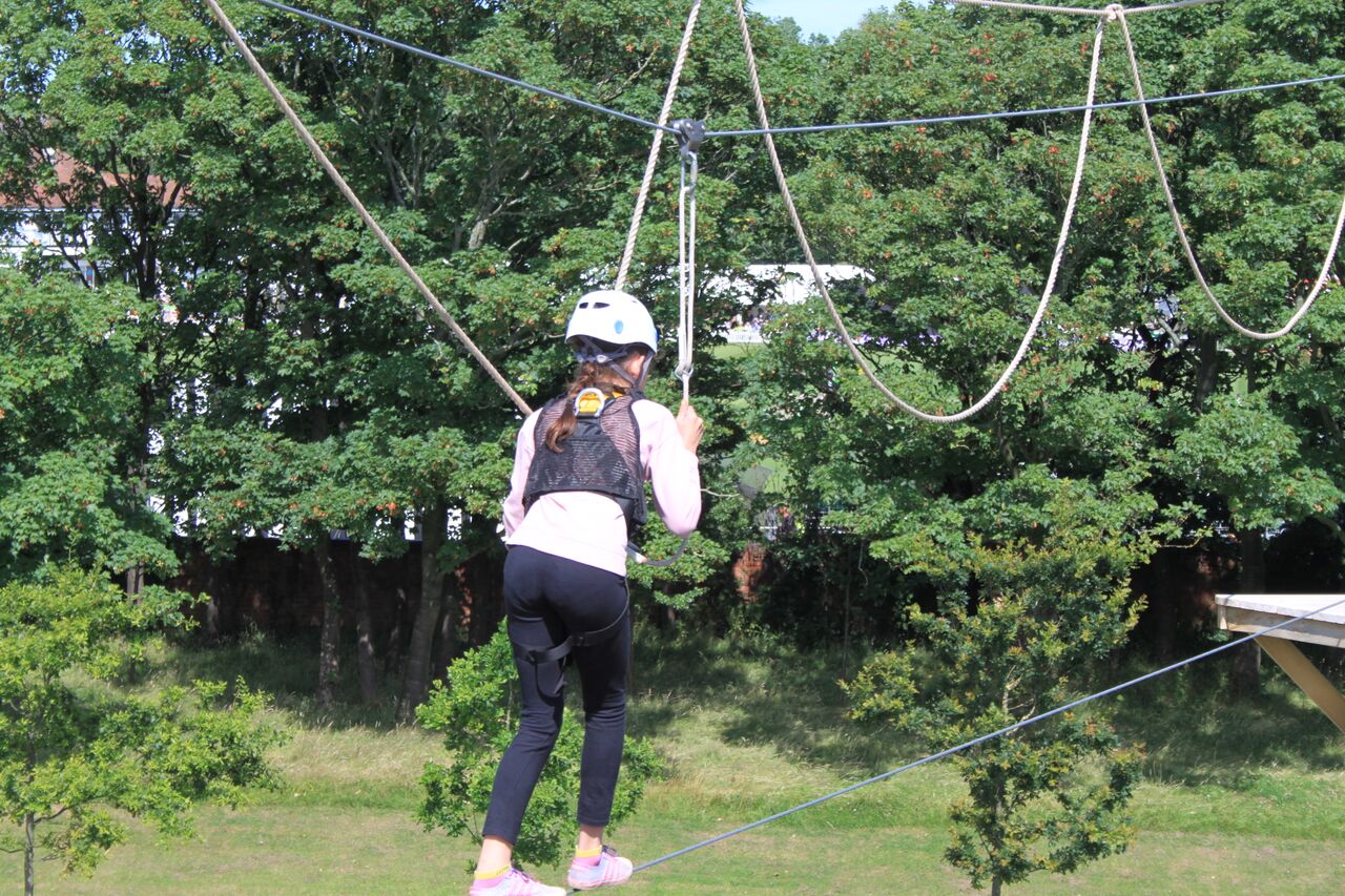 Girl balancing on high rope