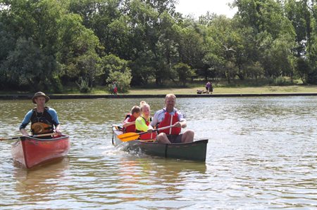 two adults and 2 children canoeing